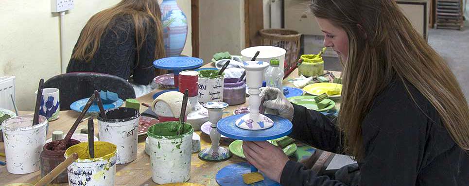 Hand painting the pottery